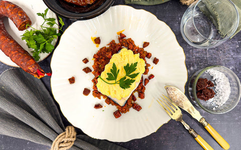 A shell-shaped place topped with black cod and a pink langoustine mousse