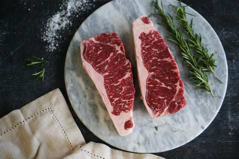Selection of raw Wagyu beef steaks with intense marbling from Japan, Australia and the UK