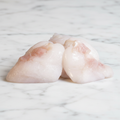 Cod Cheeks on white marble