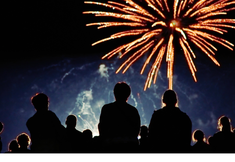 Friends watching fireworks at a bonfire party